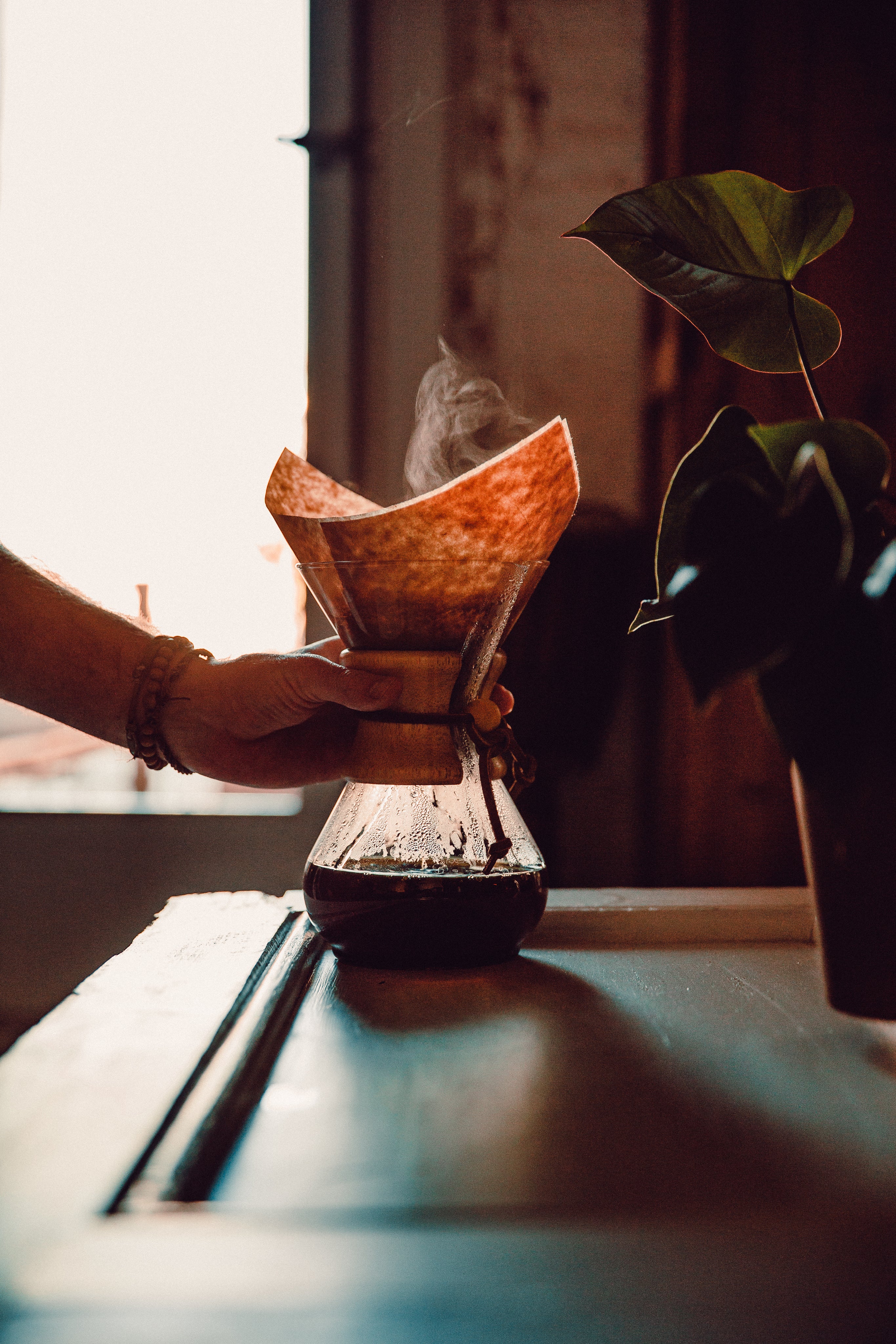 hand reaching for fresh coffee pot