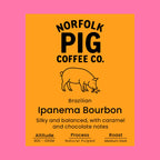 Coffee label for Brazilian Ipanema Bourbon with pig illustration on orange background
