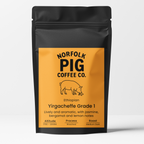 A black stand-up coffee bag with a large orange label reading Norfolk Pig Coffee Co. and Ethiopia Yirgacheffe Grade 1, shown on a clean white background.