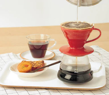 coffee being brewed with a Hario V60 coffee dripper over glass cup