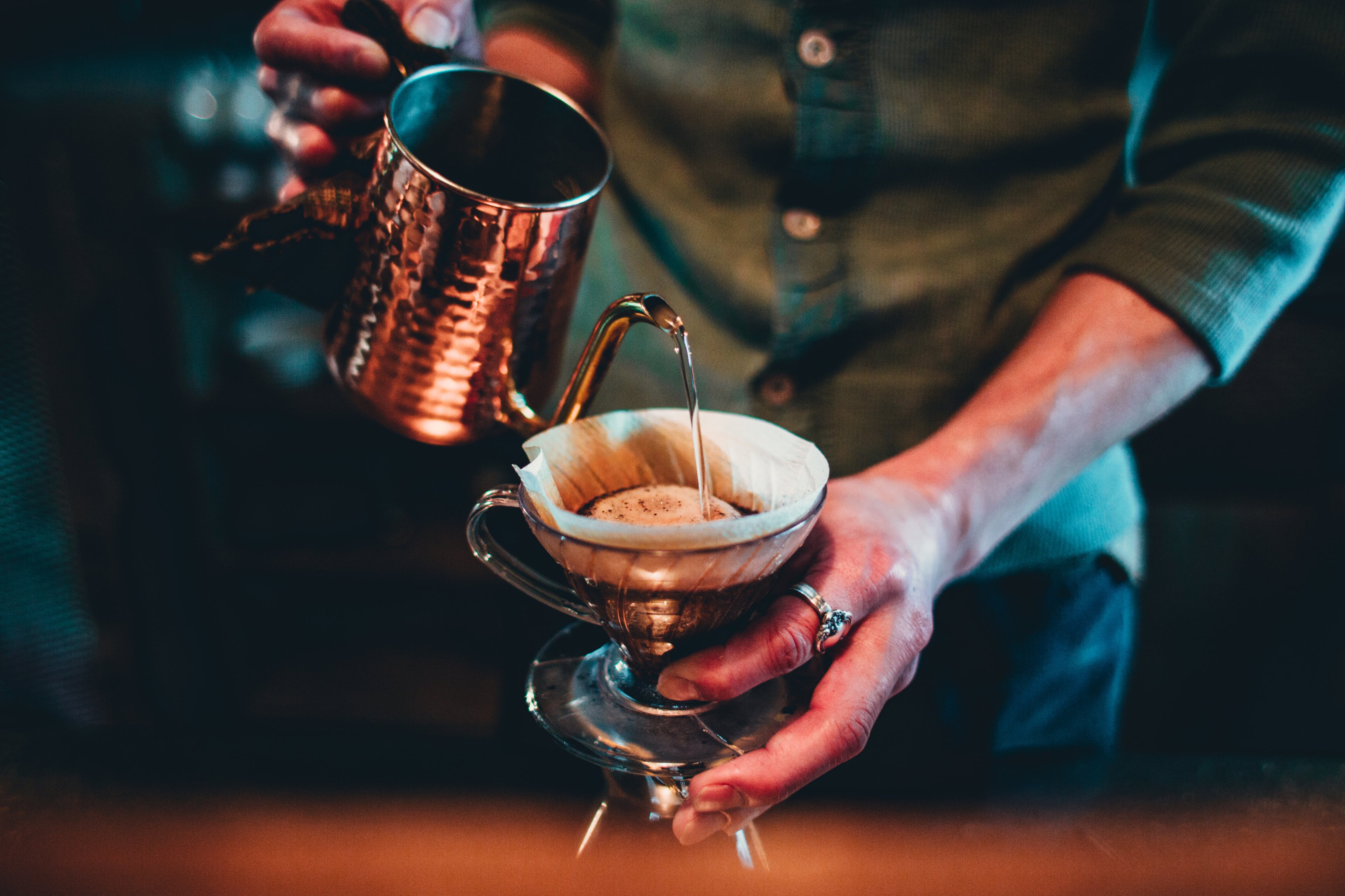 Someone pouring hot water over a filter coffee